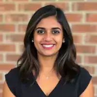 Happy customer Priya Sharma from Delhi using EcoChefBamboo serving spoons in her modern Indian kitchen for daily cooking