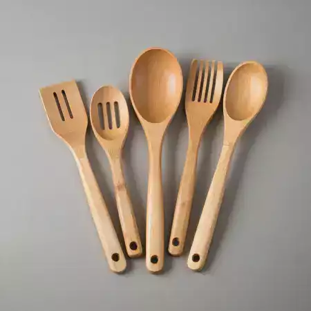 Handcrafted bamboo serving spoons and ladles designed for Indian cooking, featuring smooth surfaces and ergonomic handles for comfortable use